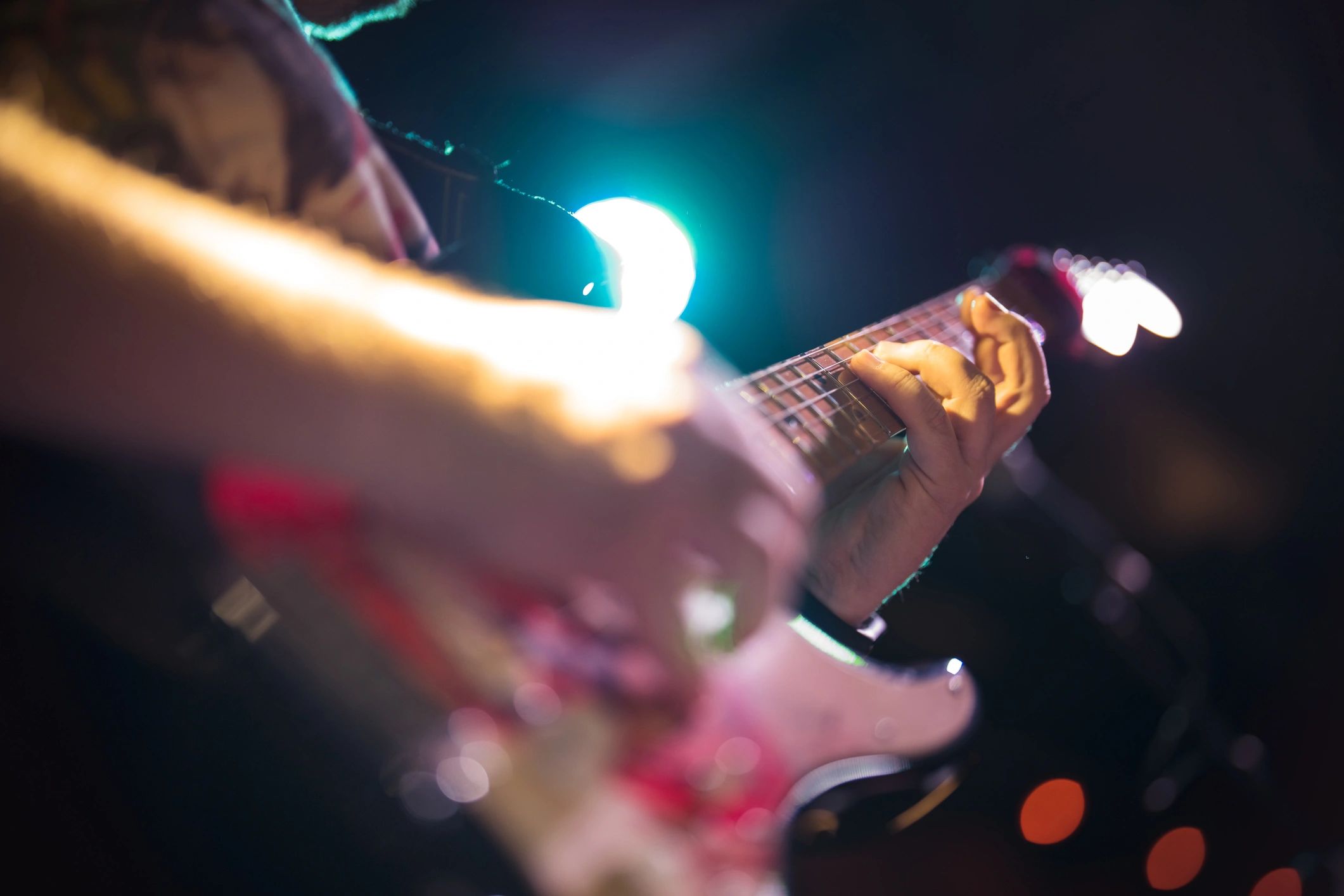 Musicians performing on stage under lights