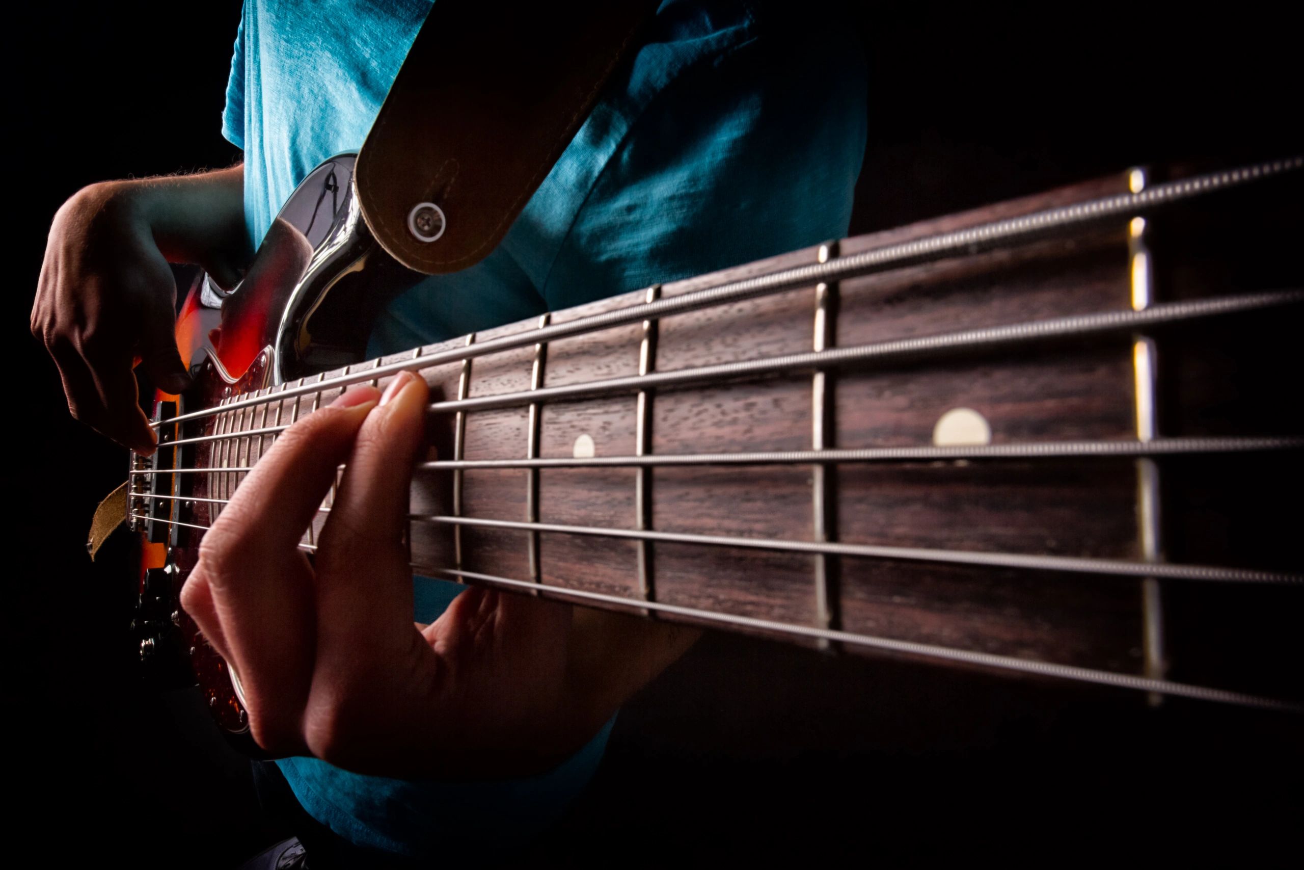 Close-up of a musician playing bass guitar